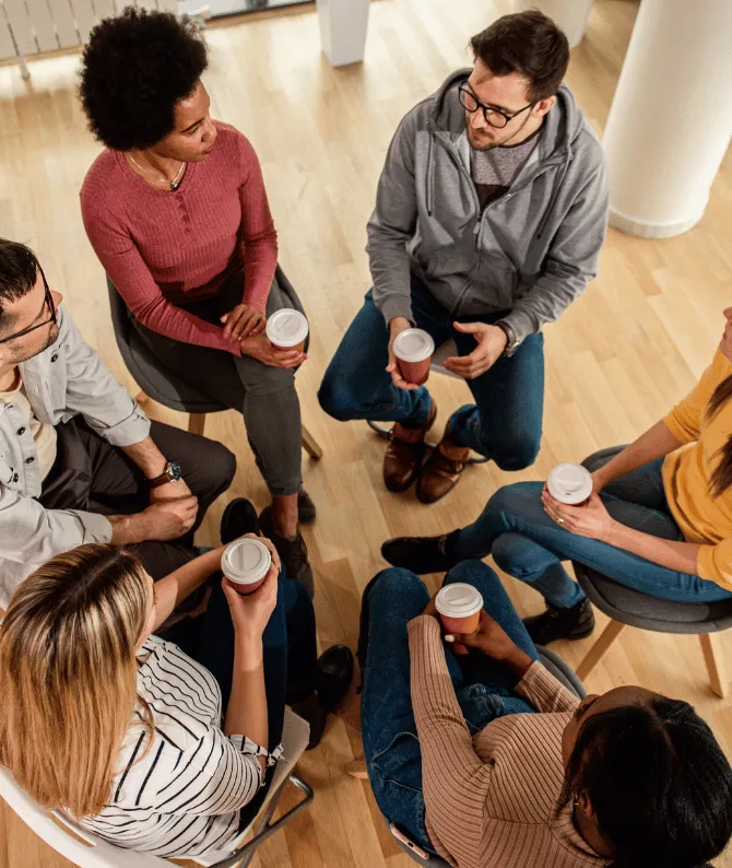 Group therapy session with people seated in a circle