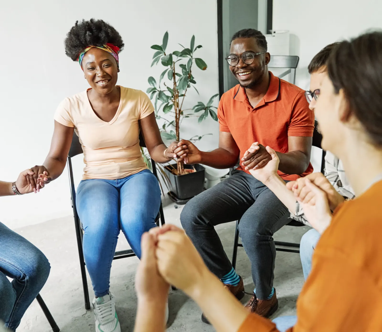 People holding hands in a support group circle